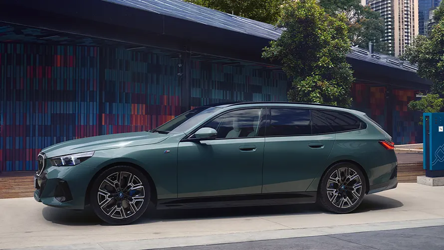 BMW i5 Touring vor urbaner Kulisse