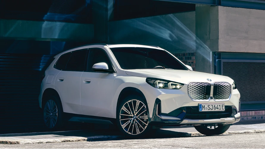 Urbaner BMW X1 vor einem Parkhaus.